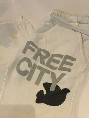 Free City women’s Cream Joggers with Grey Logo and Black Dove.